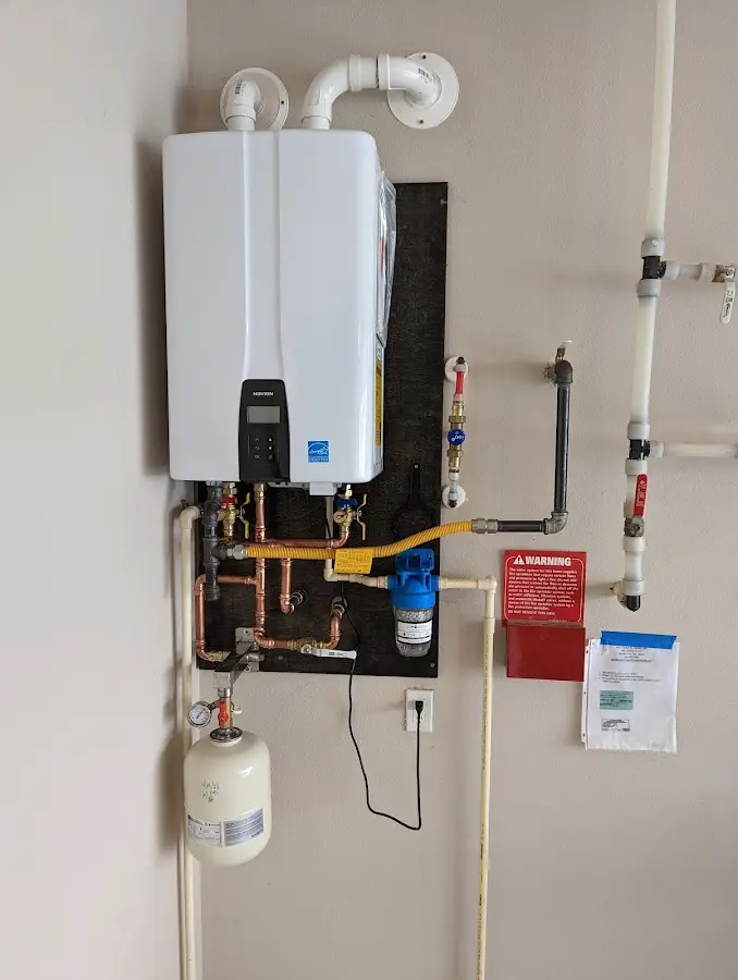 Professional plumber installing copper piping in a Kearns home